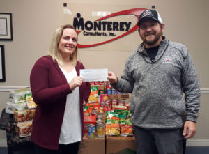 Director of Medical Records Operations Abbey Williamson gives check to the Dayton VA Food Pantry